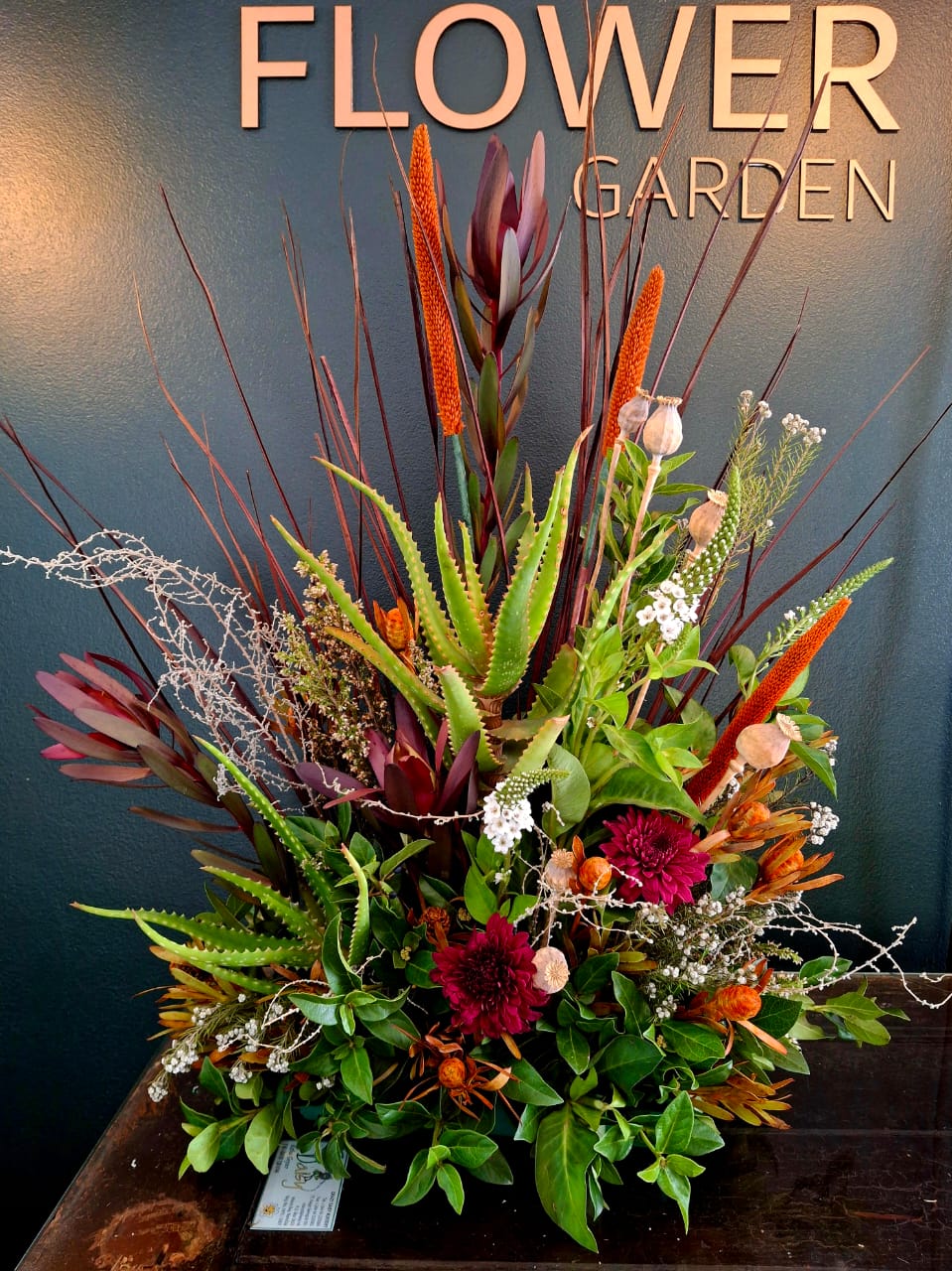 Flower Garden Walvis Bay storefront with copper signage and Edison bulb lighting