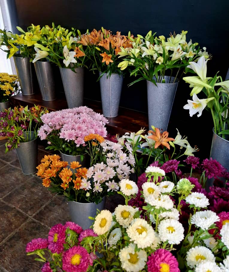 Lilies and chrysanthemums in metal buckets